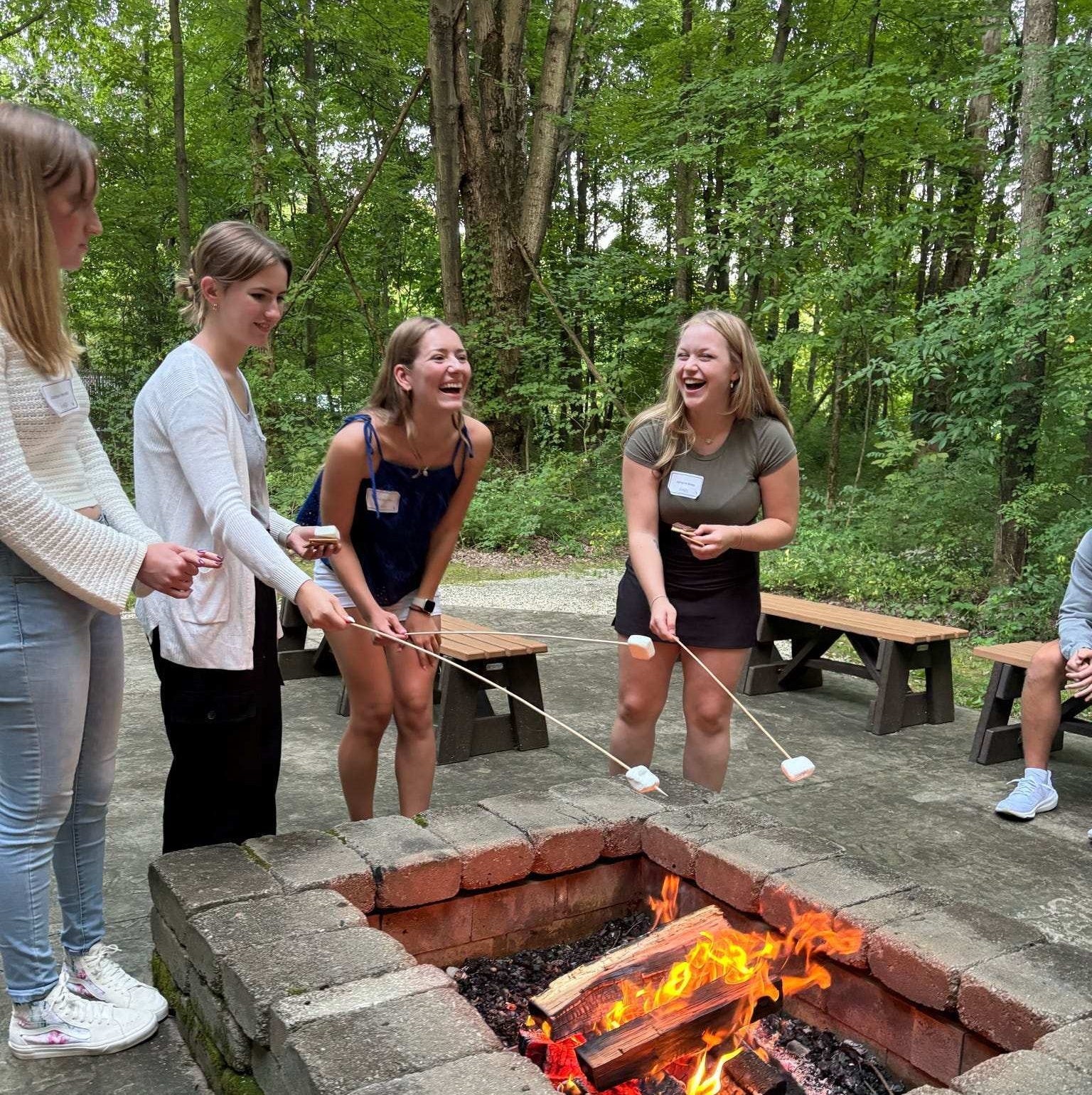 students cooking smores on fire
