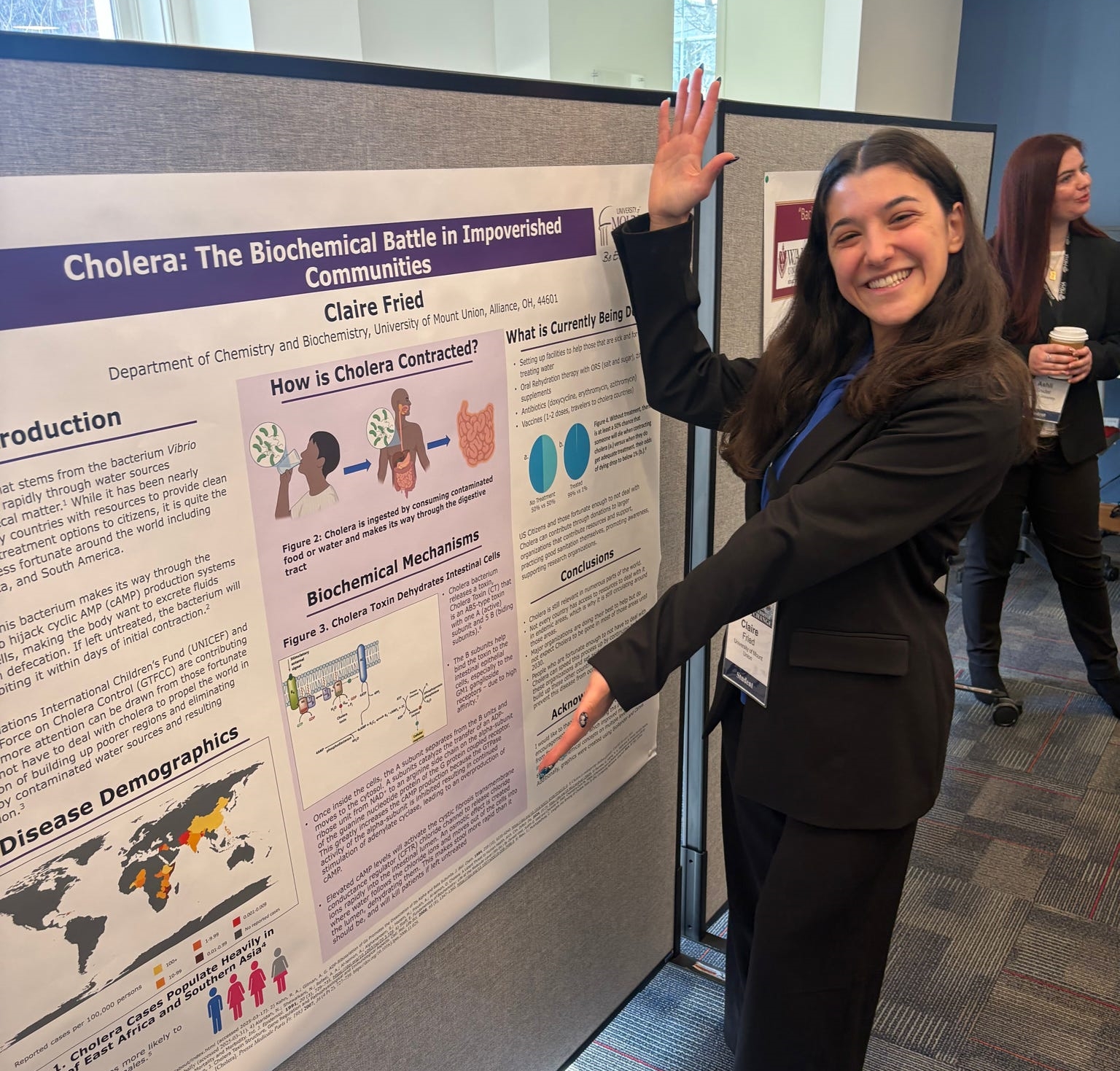 student displaying poster project