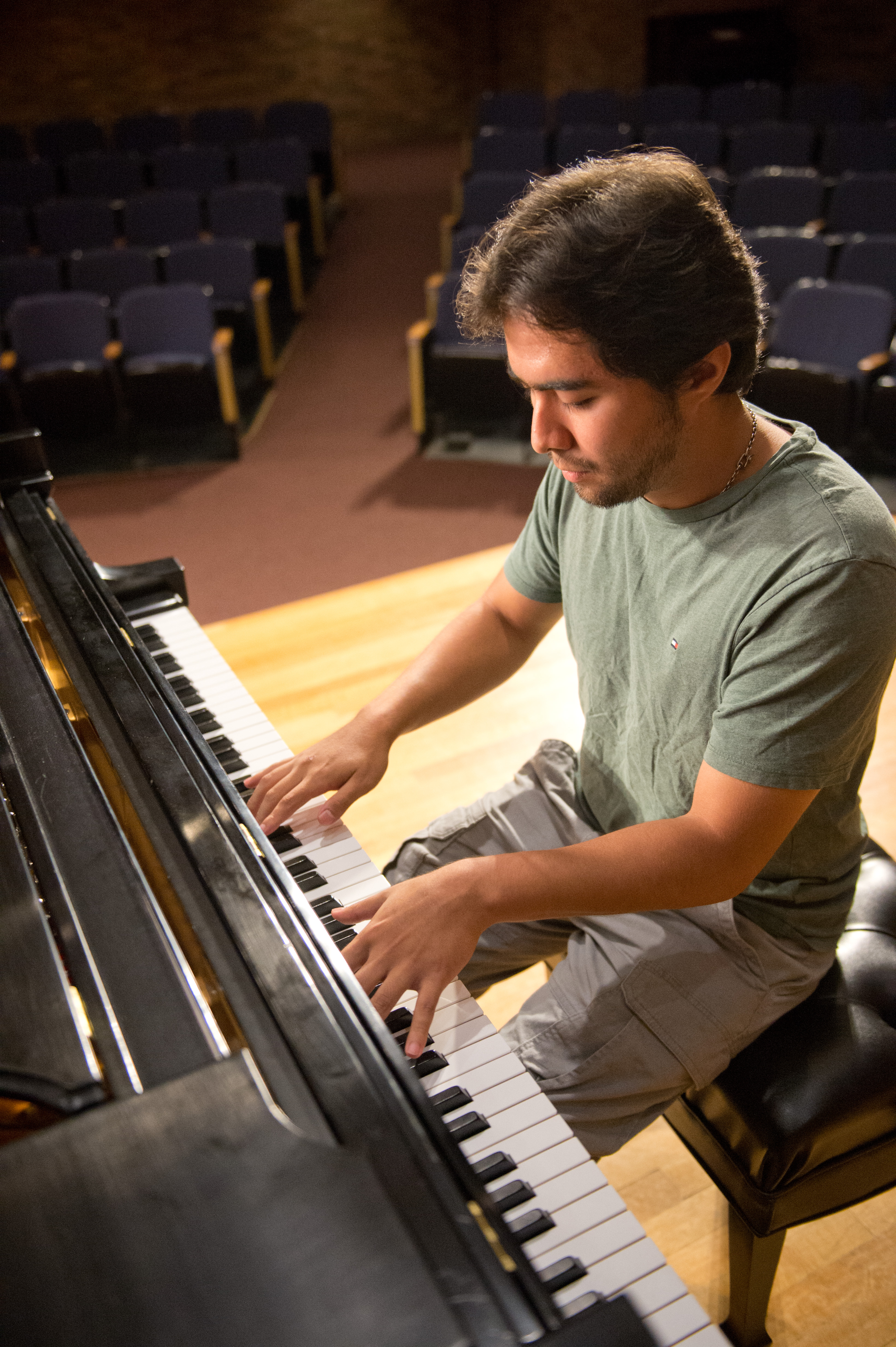 Mount Union student playing the piano on stage.