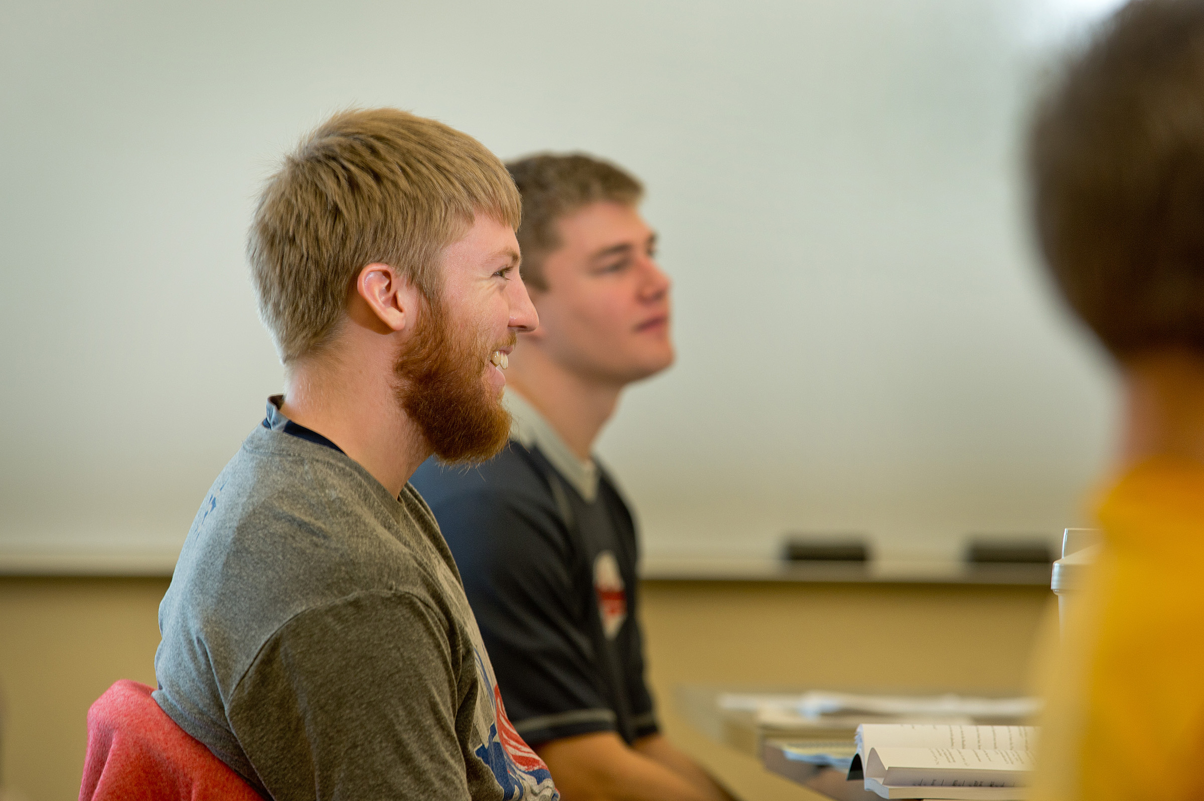 Students listening in class in front of a whiteboard