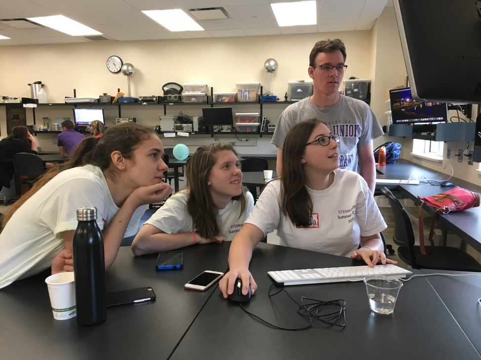 stemcoding students examine a computer programming software.
