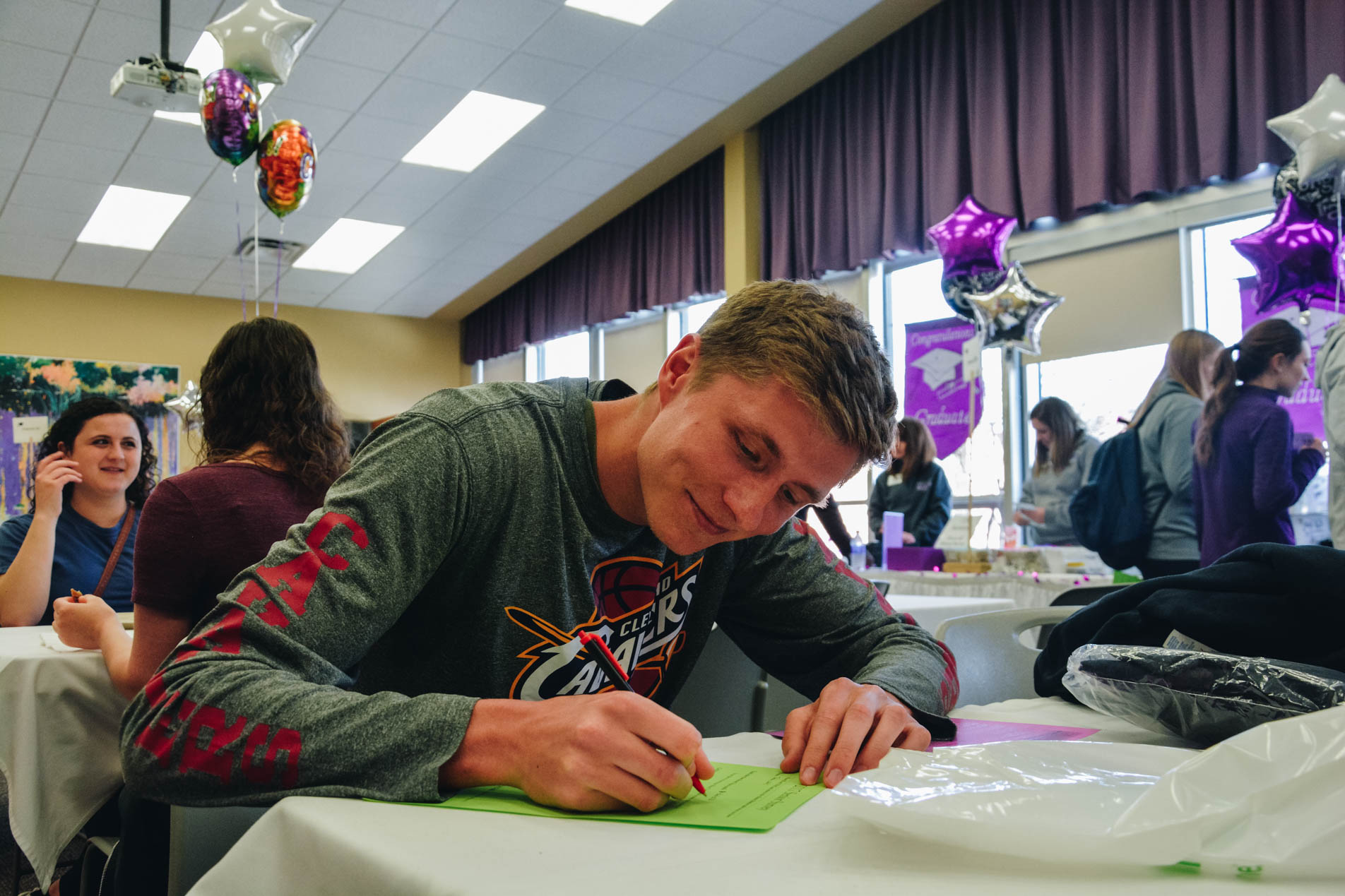 A student completing important graduation paperwork during Senior Salute