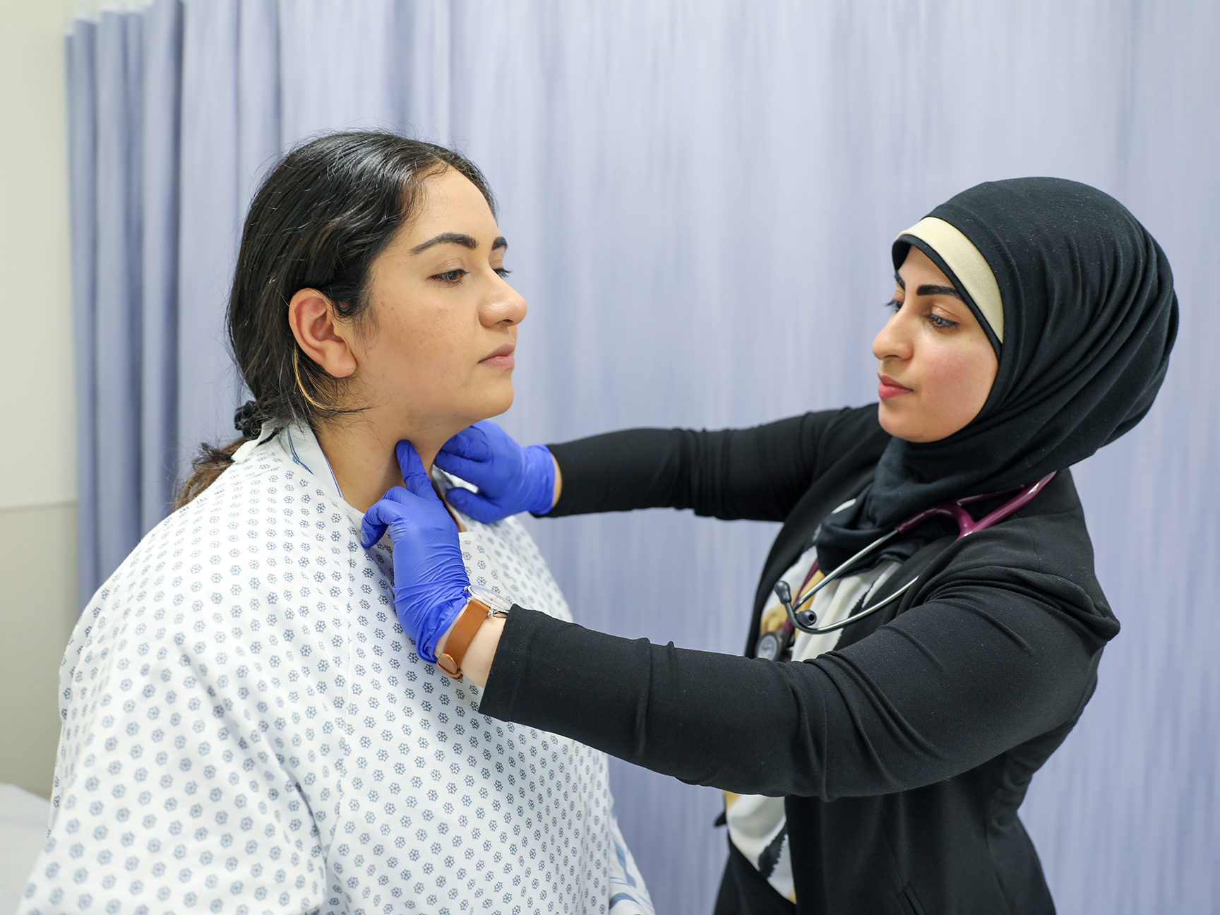 A student working with a patient in a PA classroom