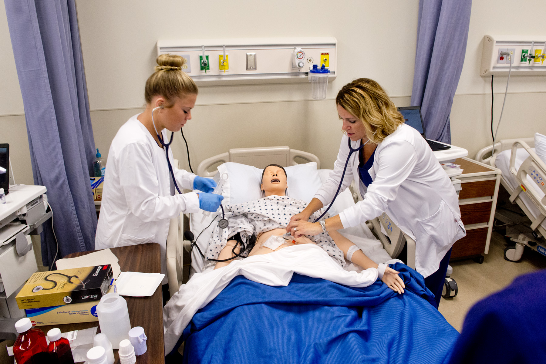 Nursing students and professor going over a project 