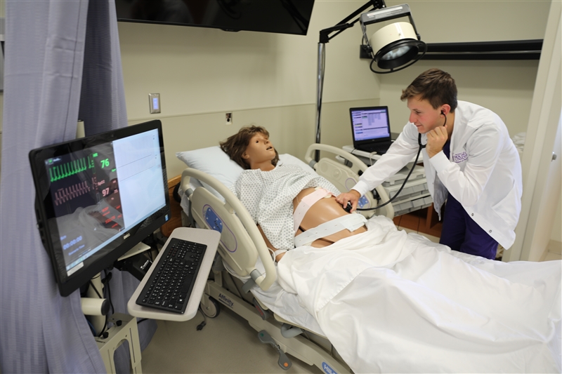 nursing student with simulation dummy