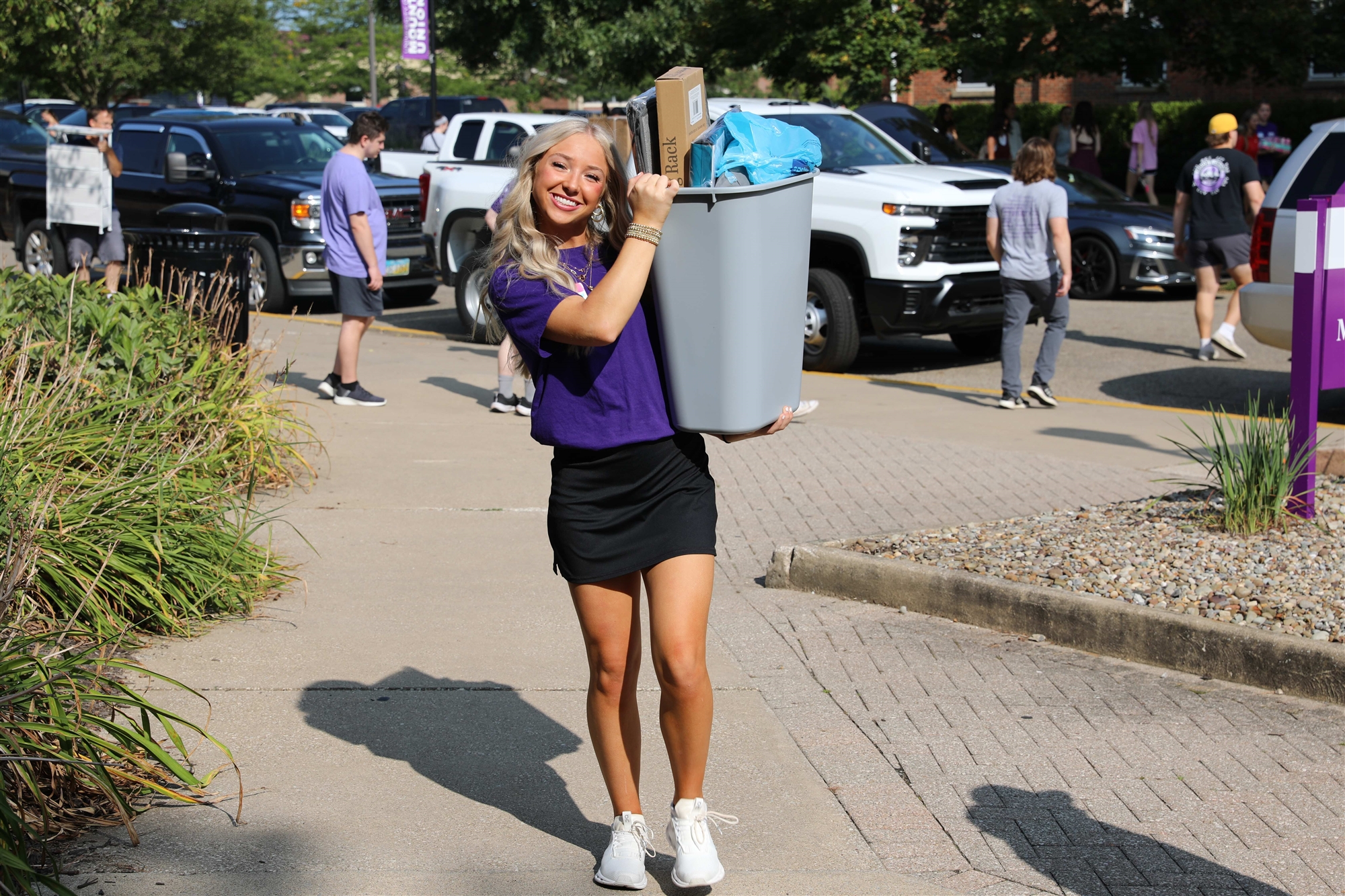 female student with bin and boxes