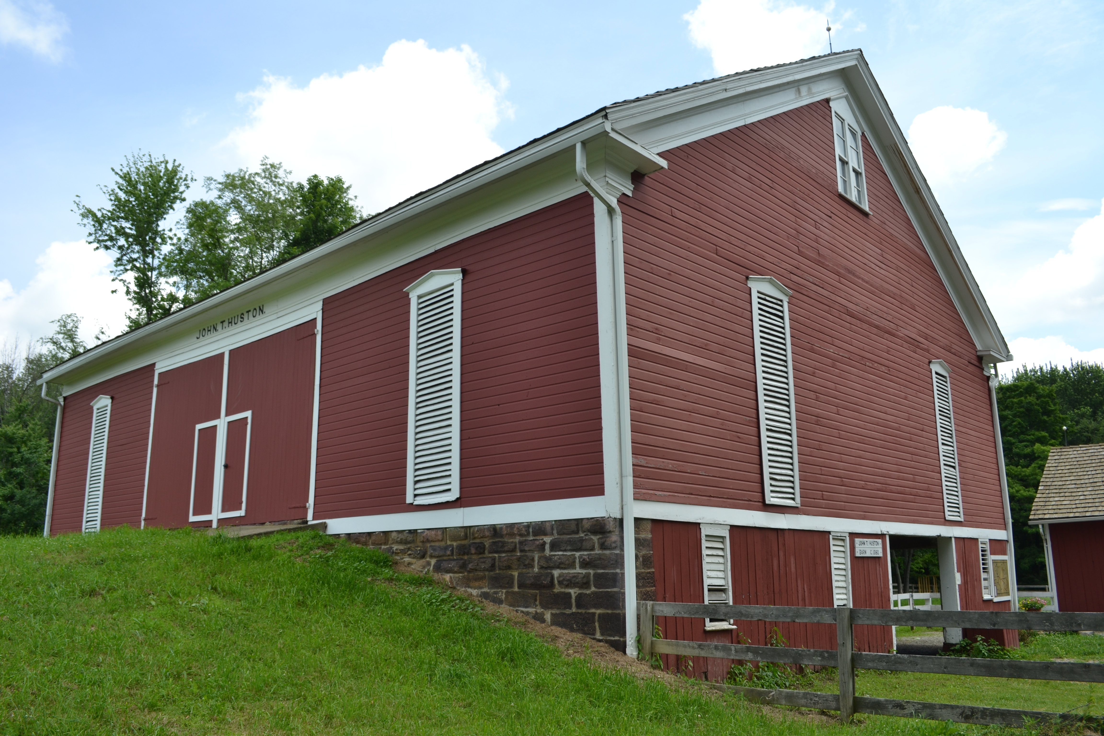 A large, historic red barn at the Nature Center