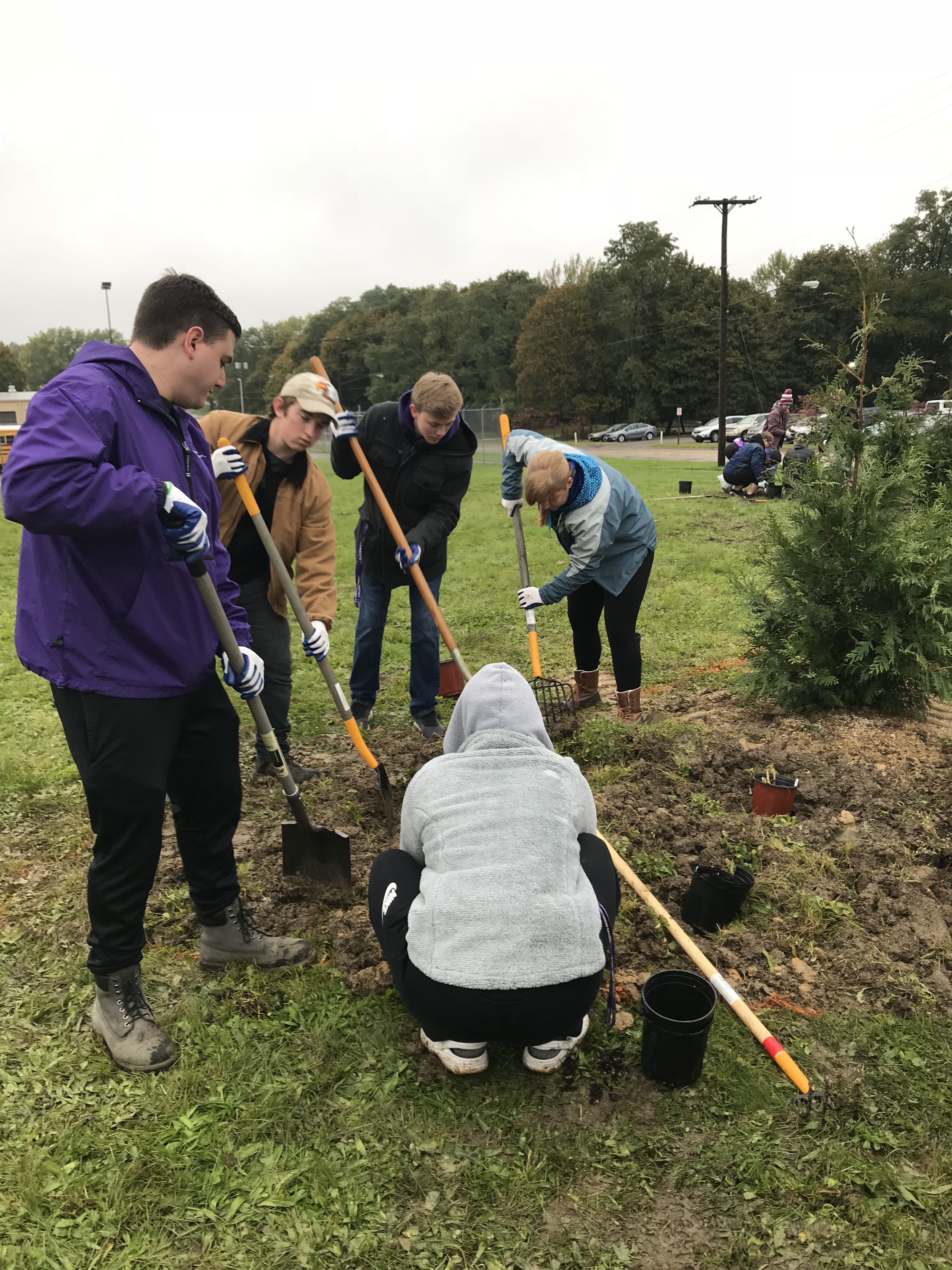 Student digging in the ground