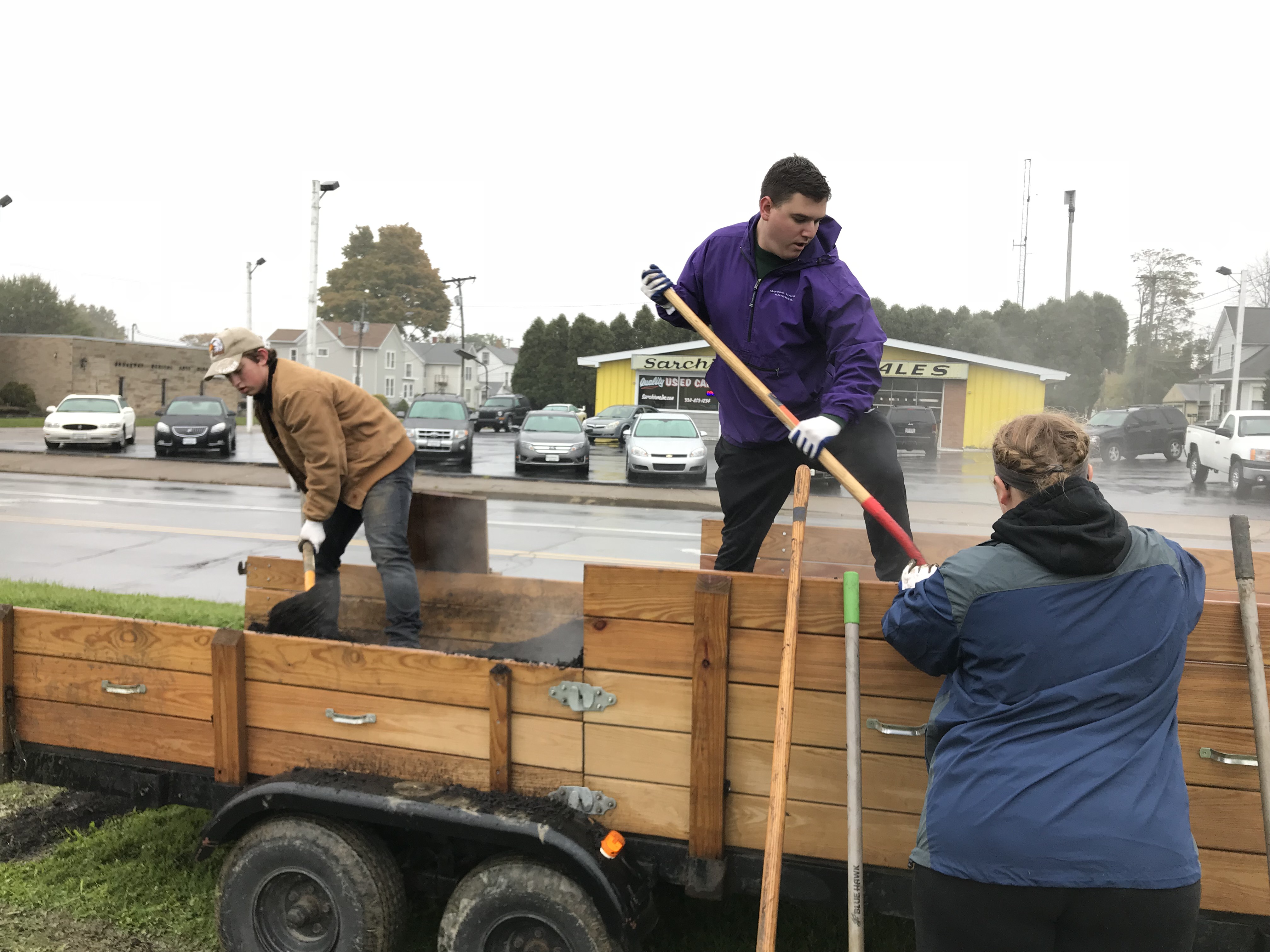 Student shoveling out of truck