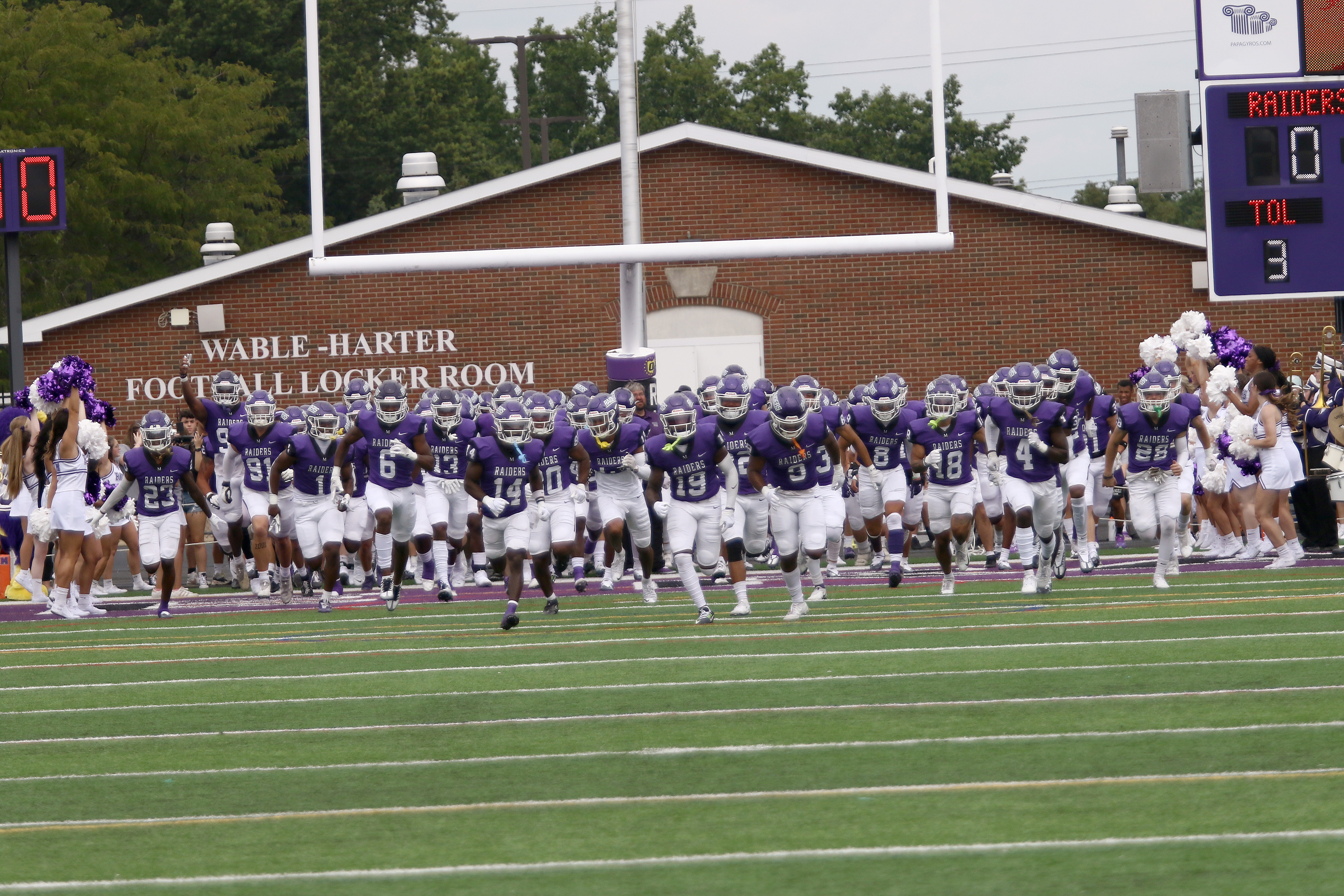 Purple Raider Football Team running onto the field in Kehres Stadium