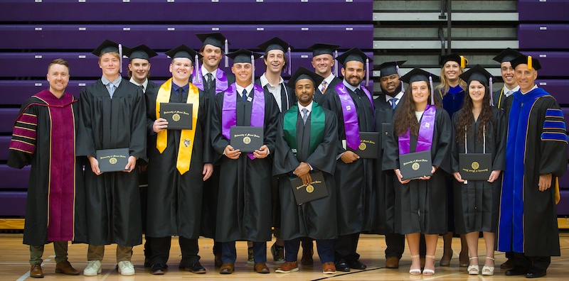 Betscakos '23 at graduation with other students