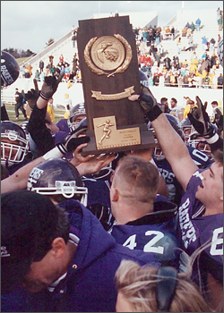 93 Football Team Holding Stagg Bowl Trophy