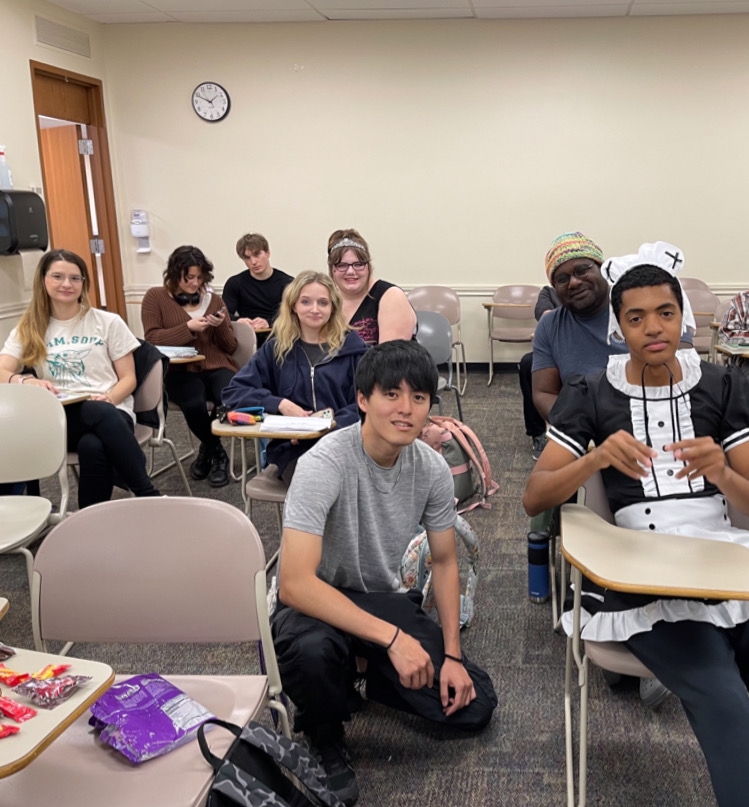 Hajime Mikamo sits in a classroom with students at Mount Union