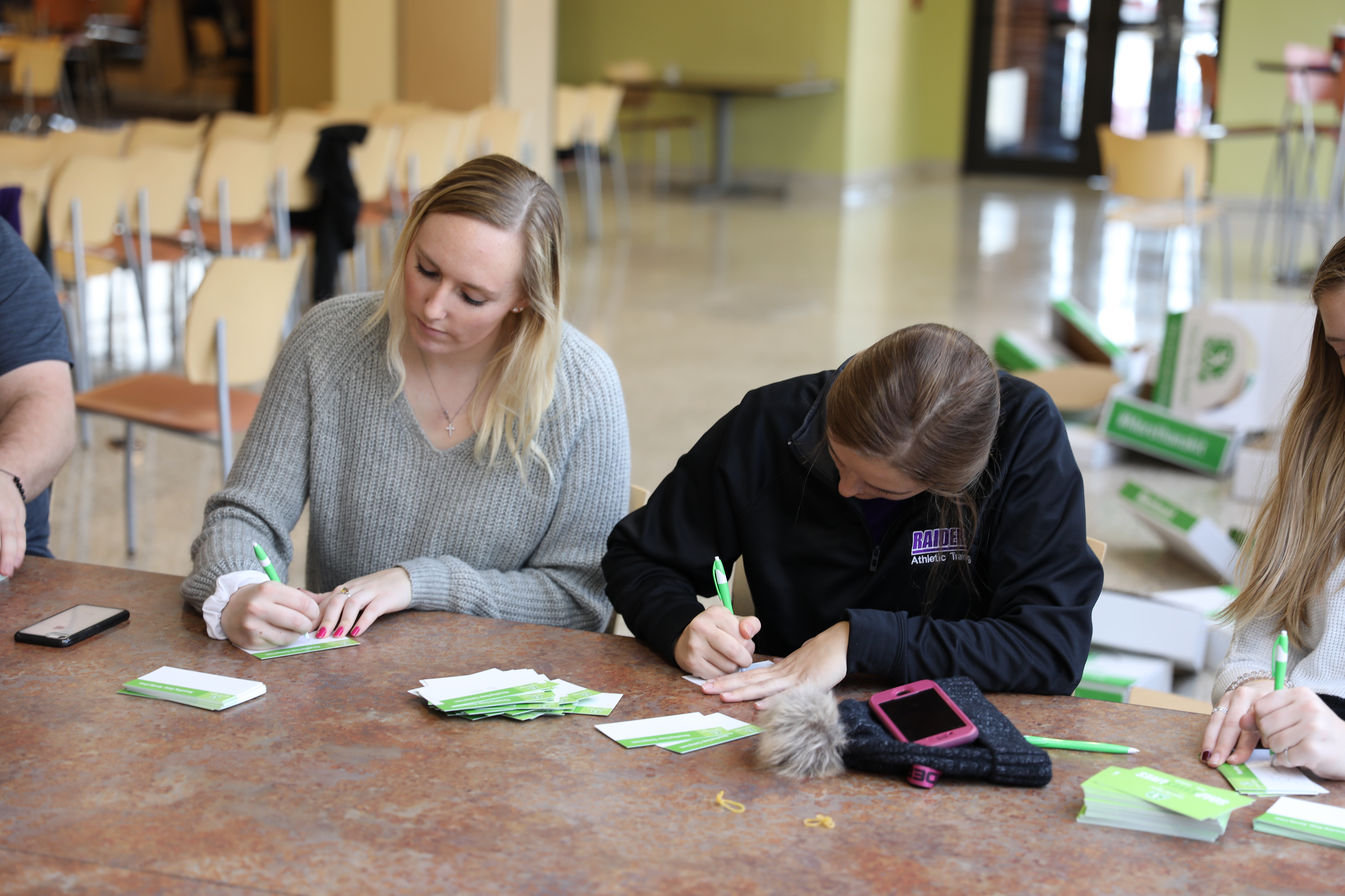 Students writing notes for hygiene kits