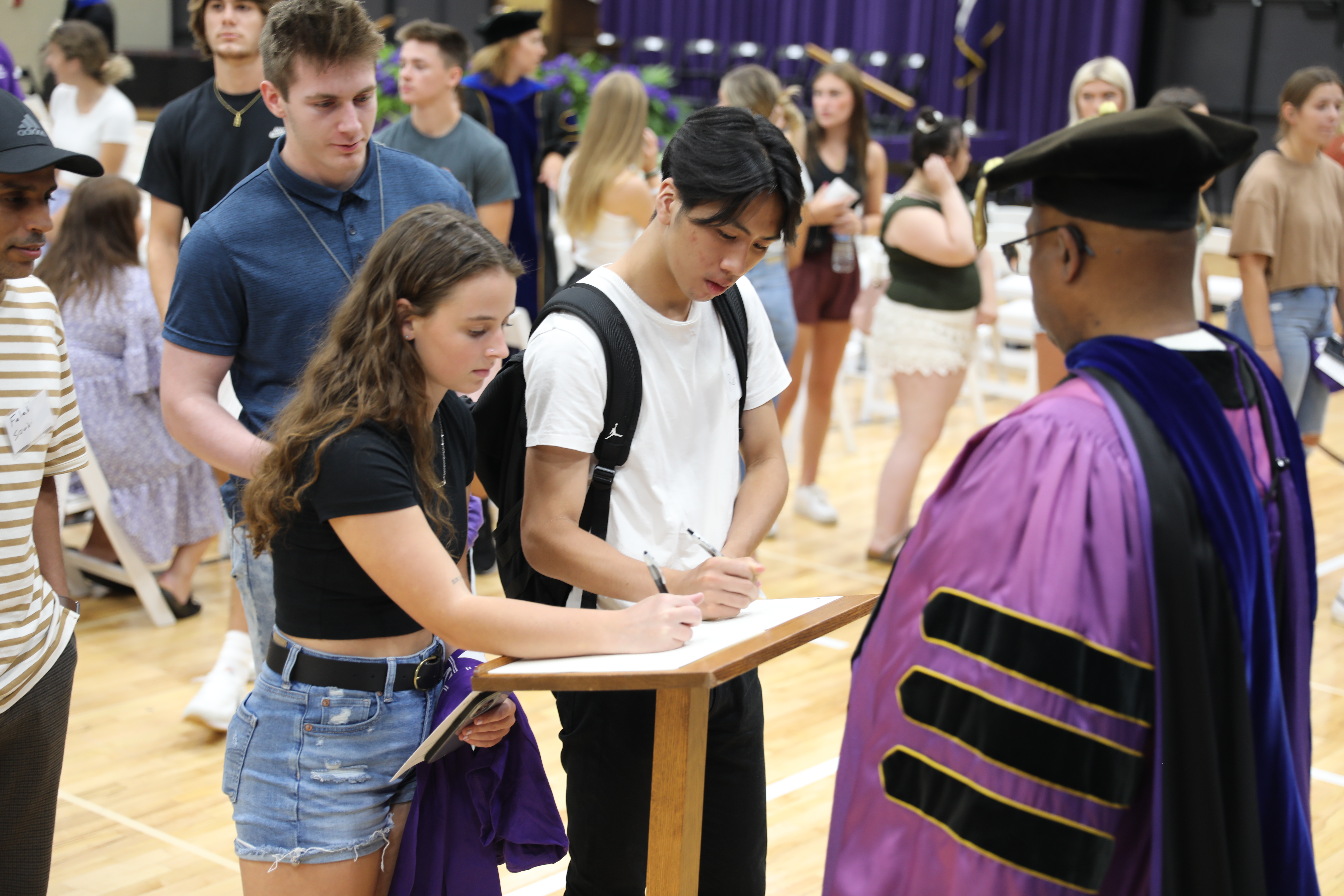 students signing book